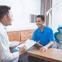 affordable:patient talking to dentist 