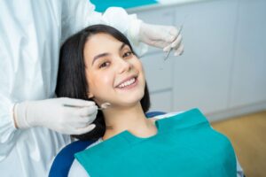 Happy dental patient undergoing exam